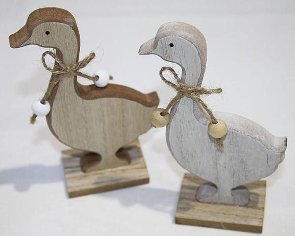 Sweet wooden goose decorated with pearls, on wide wooden