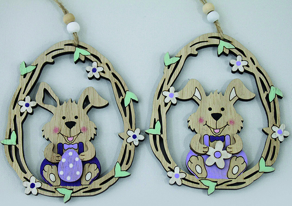 Cute bunny with flower or egg in a flower-decorated wooden