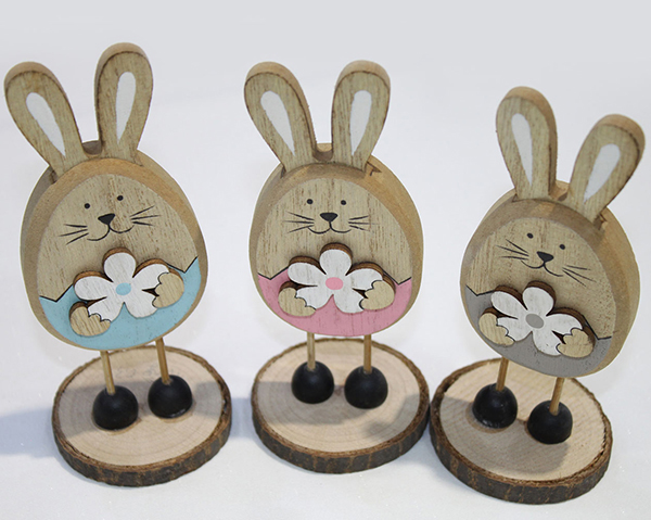 Sweet Easter bunny with flower and shoes on tree disc