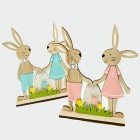 Bunnies with egg, lawn and flowers on a wooden stand